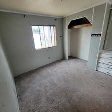 Carpeted spare room with a textured ceiling
