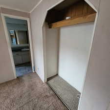 Interior space with a textured ceiling and carpet flooring