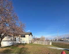 View of property exterior featuring a lawn