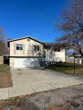 View of front of house with concrete driveway