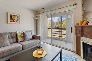 Living room featuring a fireplace and carpet floors
