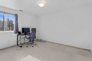 Office area with baseboards and carpet
