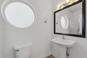 Full bath with a shower stall and toilet