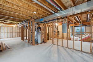 Basement featuring electric panel and a water softener system