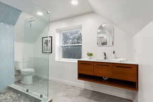 Full bath featuring vanity, walk in shower, lofted ceiling, and recessed lighting