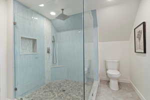 Bathroom featuring a walk in shower, vaulted ceiling, recessed lighting, and tile patterned floors