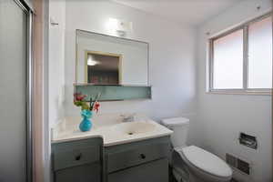 Full bathroom featuring vanity and a stall shower