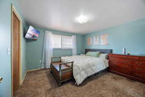 Carpeted bedroom with baseboards