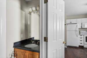 Bathroom with vanity and dark wood-type flooring