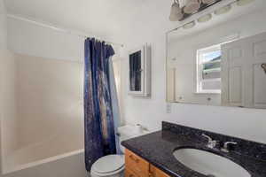 Bathroom with vanity and shower / bath combo