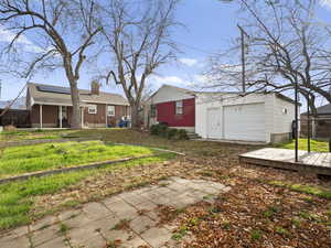View of yard featuring an outbuilding and a wooden deck
