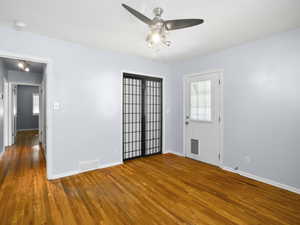 Spare room featuring hardwood / wood-style flooring and ceiling fan