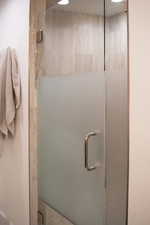 Full bathroom featuring a shower stall