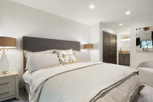 Bedroom with a closet, recessed lighting, and ensuite bath