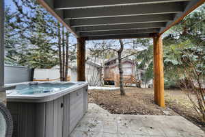 View of yard with a hot tub and a patio