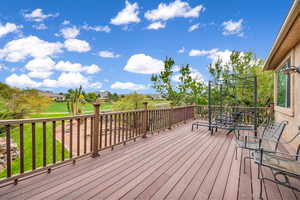 Deck featuring a residential view, a yard, and outdoor dining area