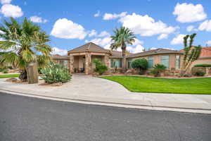 View of front of property featuring a front yard, stone siding, and a tile roof