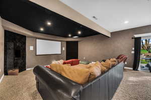 Cinema featuring light carpet, beam ceiling, and recessed lighting