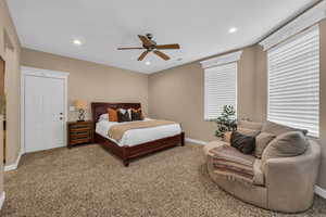 Carpeted bedroom featuring a ceiling fan and recessed lighting