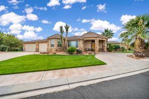 Ranch-style house with stone siding, driveway, a front yard, stucco siding, and a tiled roof