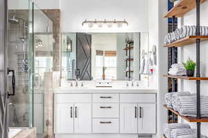 Bathroom with double vanity and a shower stall