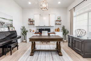 Office space with a chandelier, recessed lighting, and light wood-style flooring
