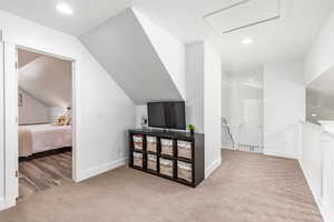 Bonus room featuring recessed lighting, light colored carpet, lofted ceiling, and attic access