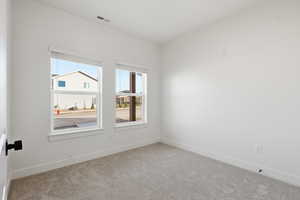 Unfurnished room with carpet floors and baseboards