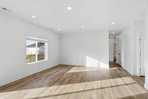 Spare room with light wood-style flooring and recessed lighting