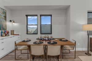 Dining room with light wood-type flooring and baseboards