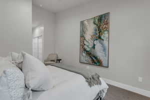 Bedroom featuring baseboards and carpet floors