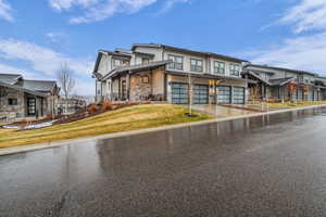 Contemporary home with a residential view, driveway, a front lawn, covered porch, and a garage