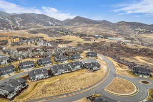 Aerial overview of property's location with mountains and nearby suburban area