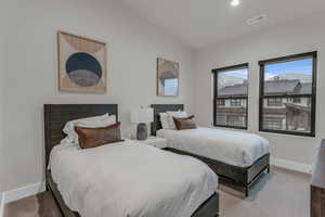 Bedroom with vaulted ceiling and recessed lighting