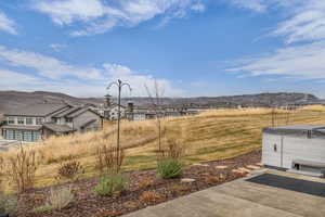 View of grassy yard with a mountain view and a residential view