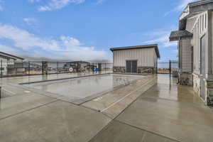 View of property's community with a swimming pool and a patio