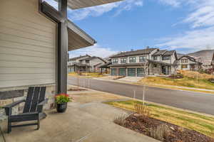 View of asphalt road with a residential view and sidewalks