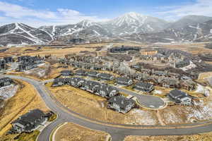 Aerial overview of property's location featuring a mountain backdrop and nearby suburban area