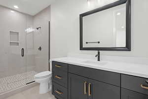 Bathroom with vanity, recessed lighting, a stall shower, and light tile patterned flooring