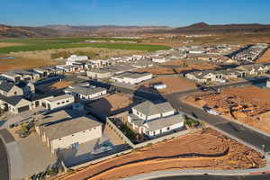 Aerial view of property's location featuring nearby suburban area and a mountainous background