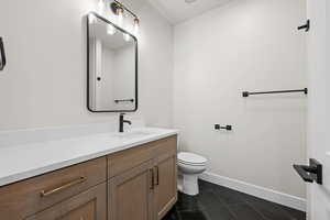 Bathroom with vanity and dark tile patterned flooring