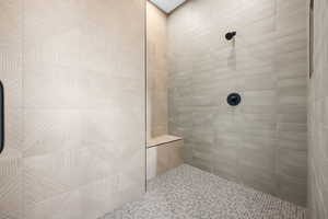 Full bathroom featuring a tile shower