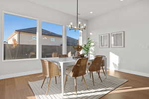 Dining space featuring wood finished floors, a chandelier, and recessed lighting