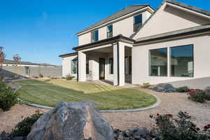 Back of property with stucco siding and a patio