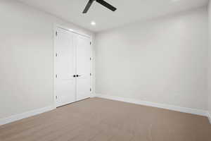Unfurnished bedroom with carpet floors, recessed lighting, a closet, and ceiling fan