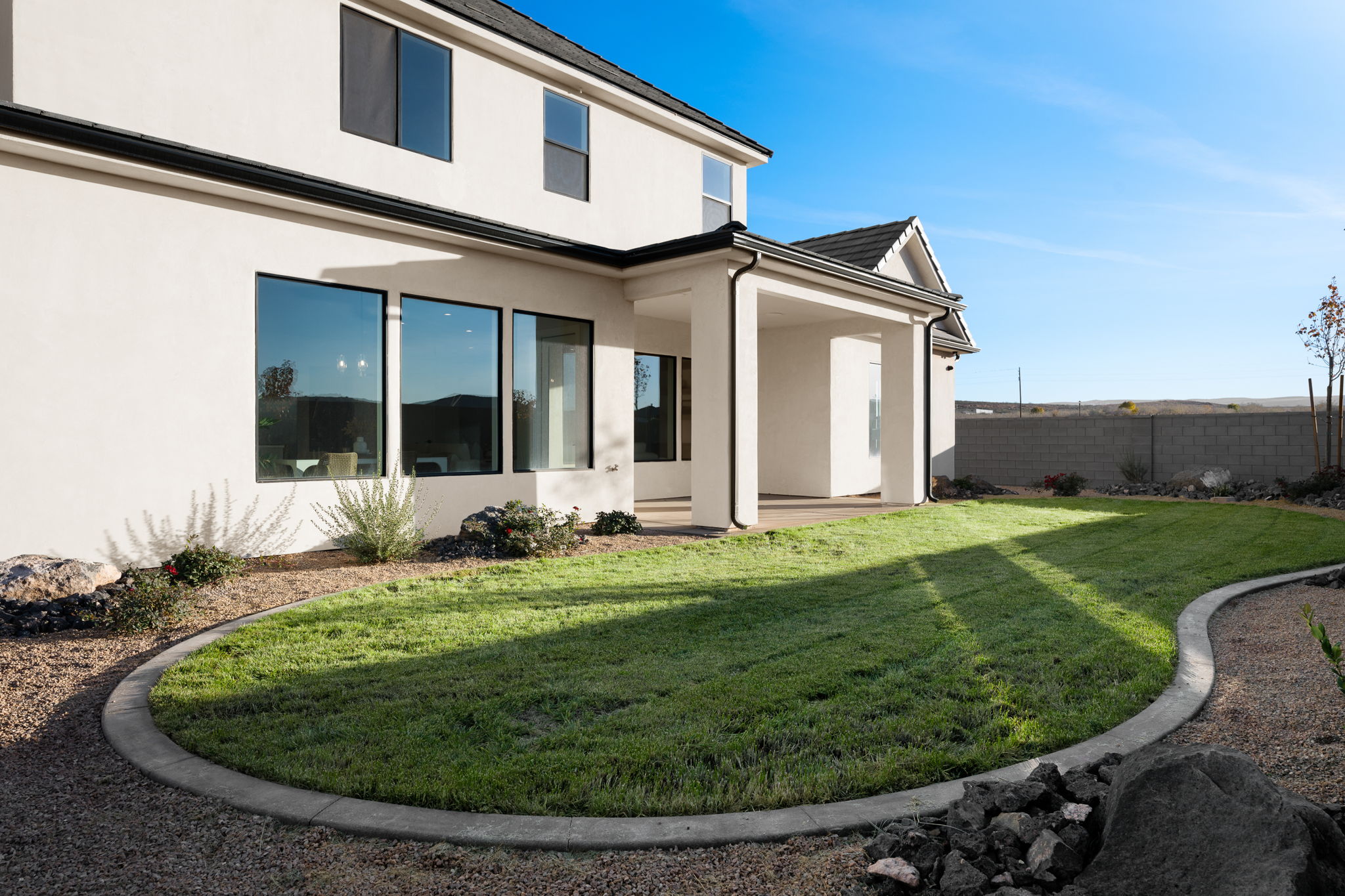 Rear view of property with stucco siding and a patio
