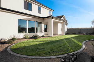 Rear view of property with stucco siding and a patio