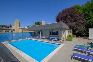 Community pool with a patio
