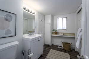 Bathroom featuring vanity and dark wood-style flooring