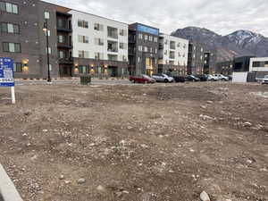 View of apartment building / complex with uncovered parking and a mountain view